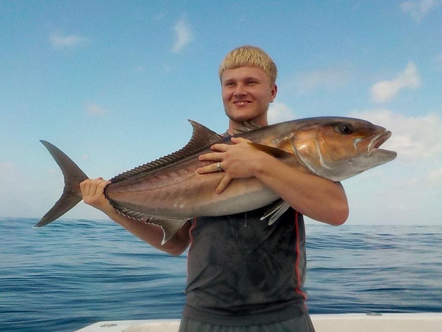 Angler holding an amberjack caught in the Gulf of Mexico